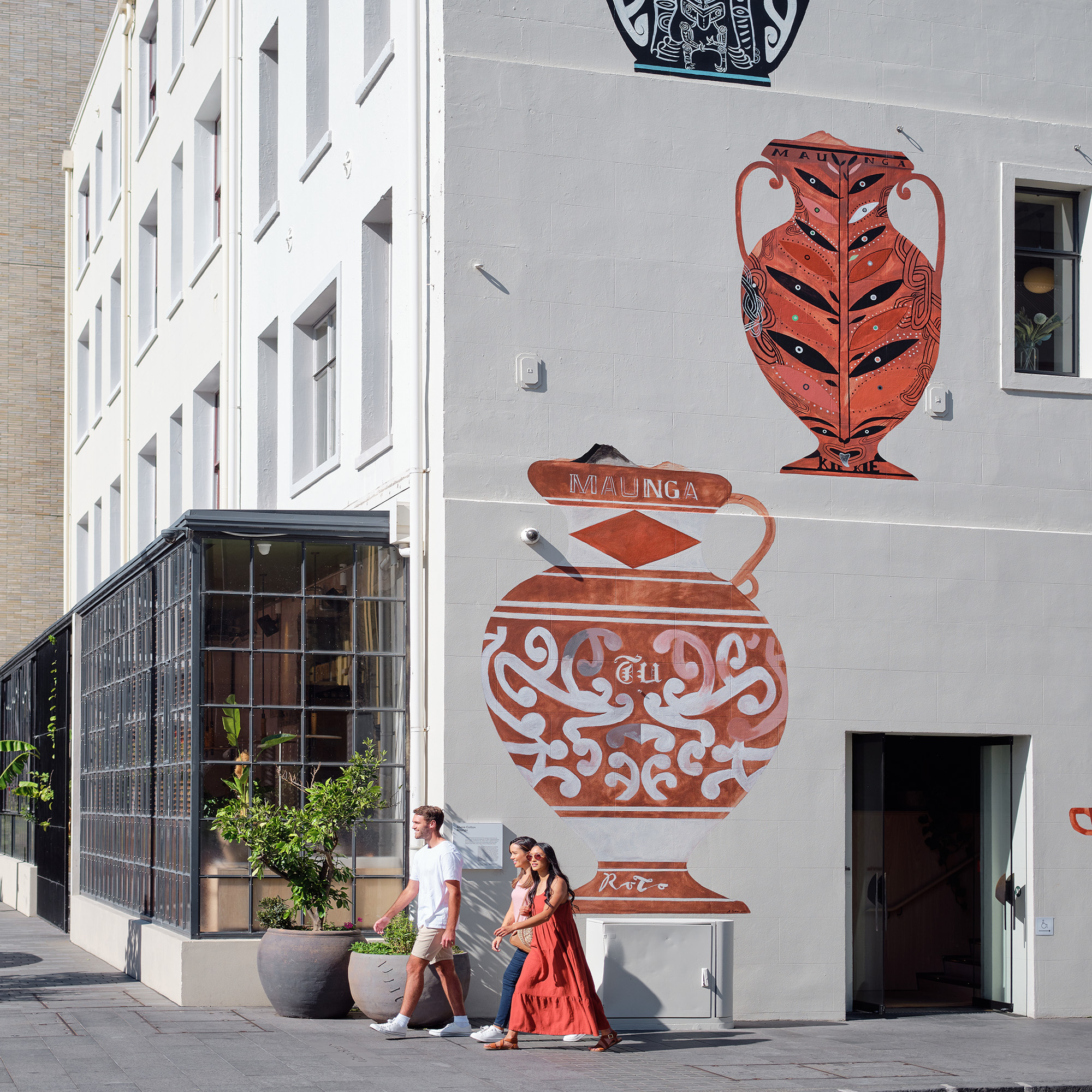 Group of friends walking past street art 2